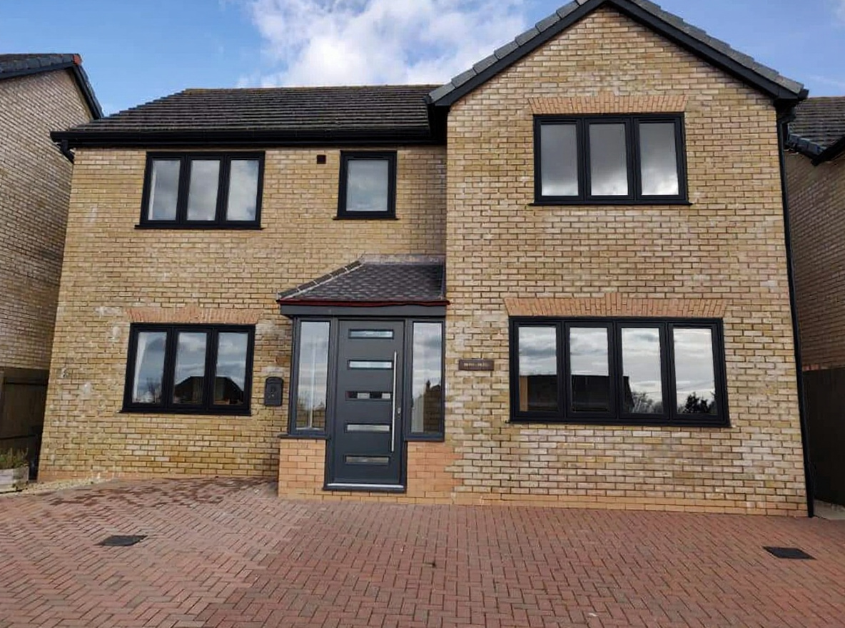 After: black flush frames on terraced house