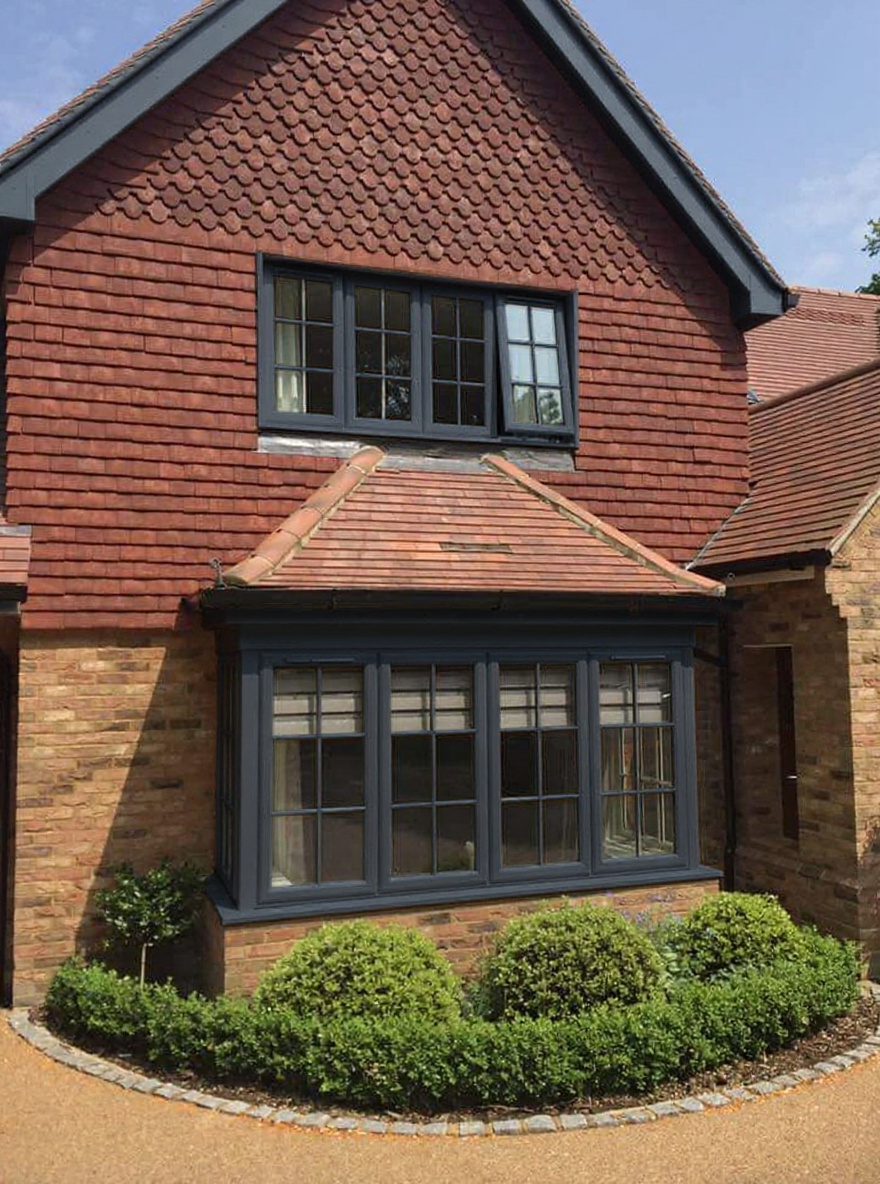 After: white casement frames on detached house